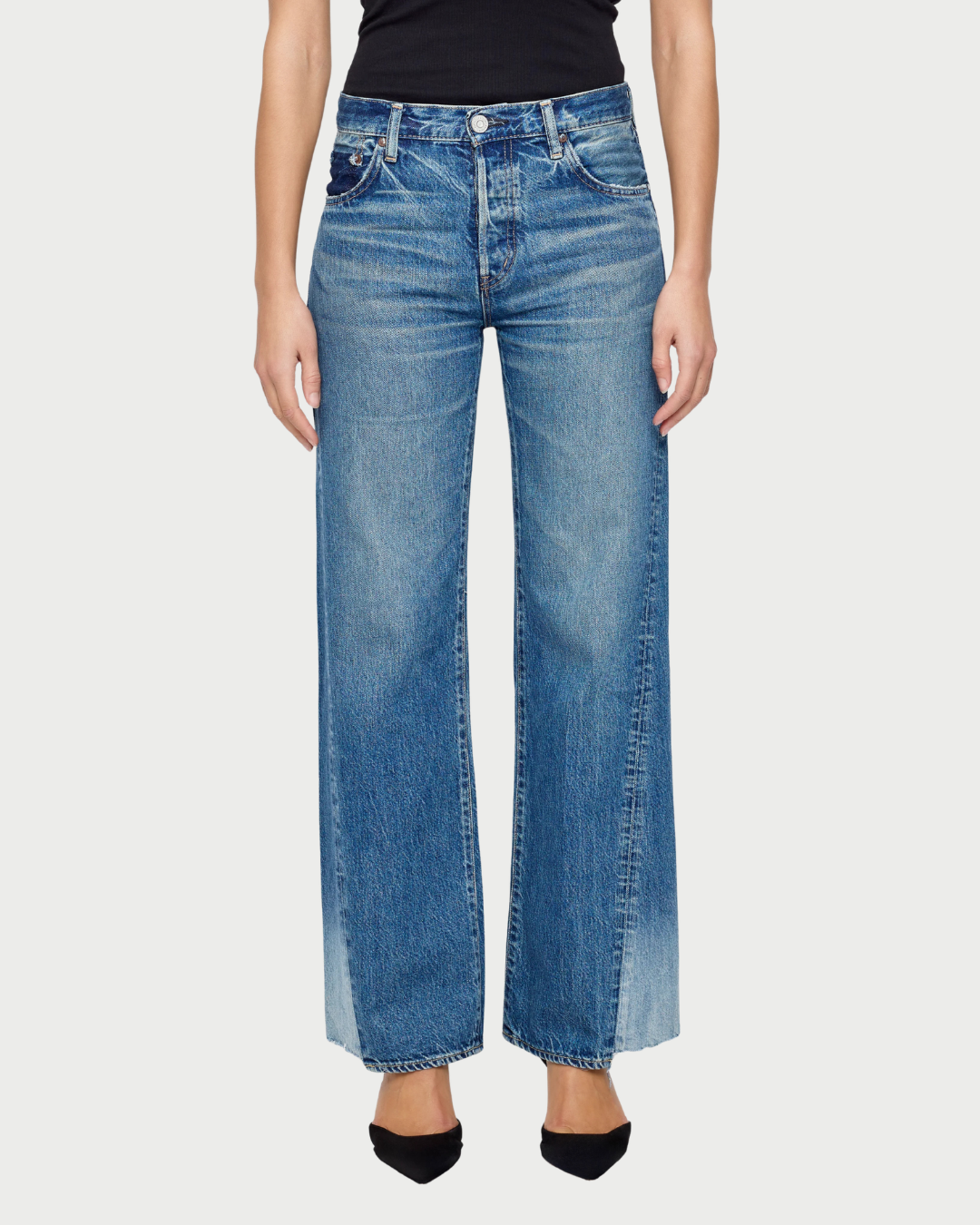 Person wearing blue jeans on a white background