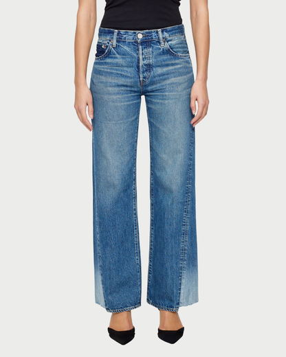 Person wearing blue jeans on a white background