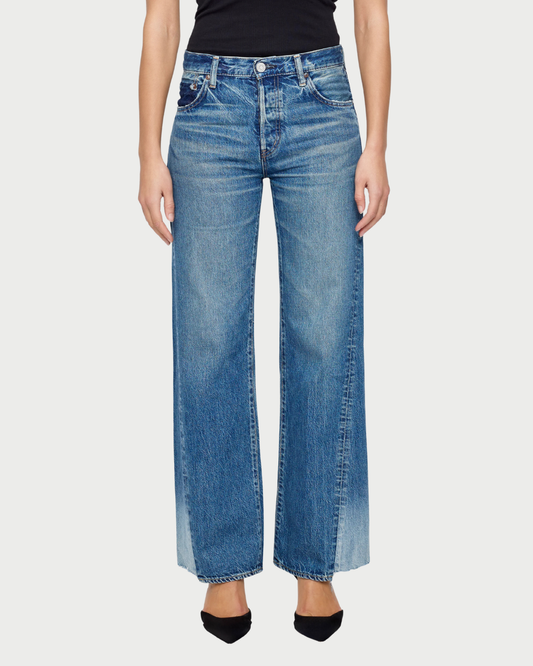 Person wearing blue jeans on a white background
