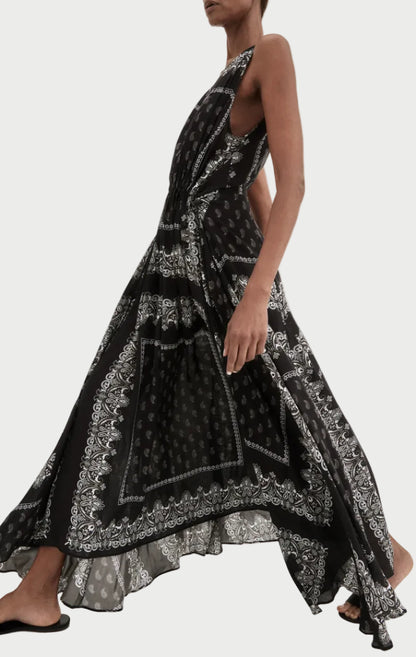 Woman wearing a black and white patterned dress on a white background