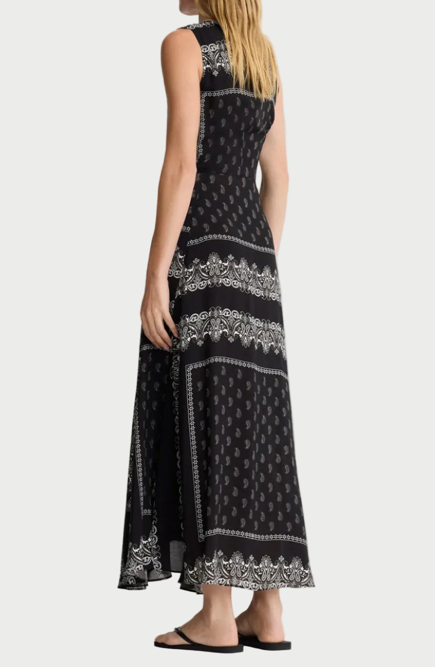 Woman wearing a black patterned dress on a white background