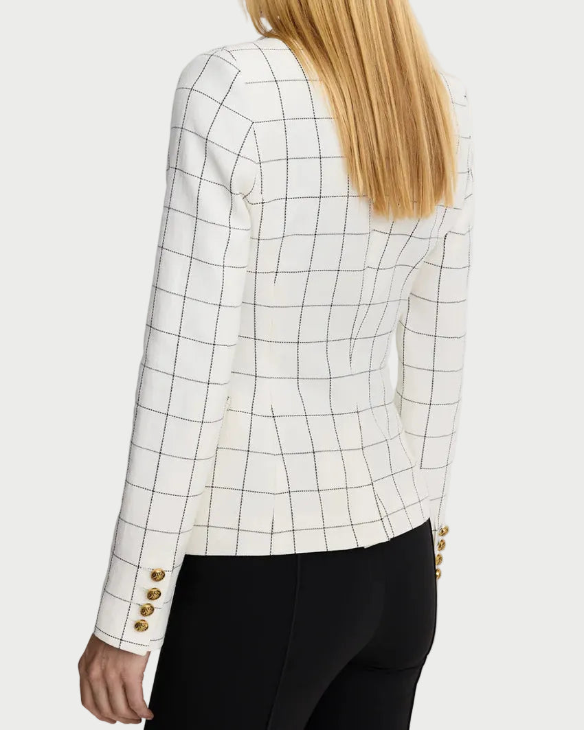 Person wearing a white checkered blazer with gold buttons on a light gray background