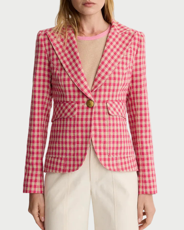 Woman wearing a red and white checkered blazer on a plain background