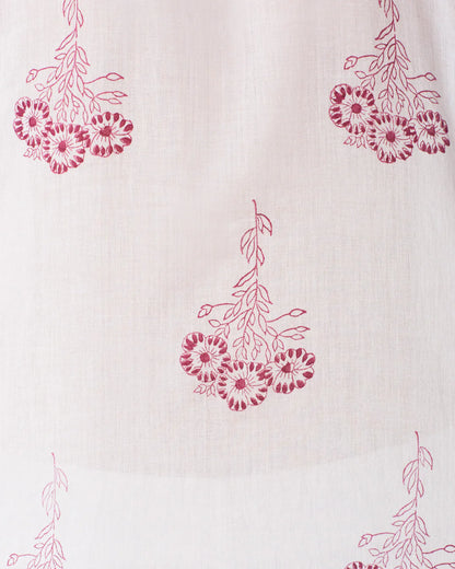 This close-up showcases the Pansy Sky Short Sleeve Shirt by Alix of Bohemia, featuring a vintage-inspired design with red floral clusters on light beige cotton voile. The hand-block printed, intricate petal details form an evenly spaced pattern perfect for stylish wear.