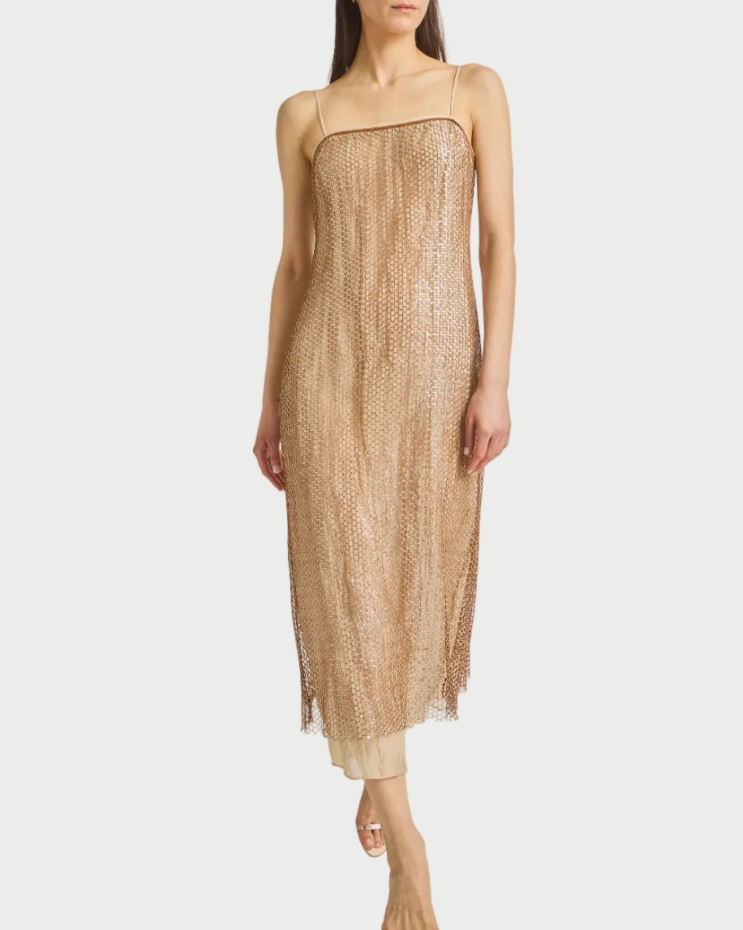 Woman wearing a beige dress on a white background