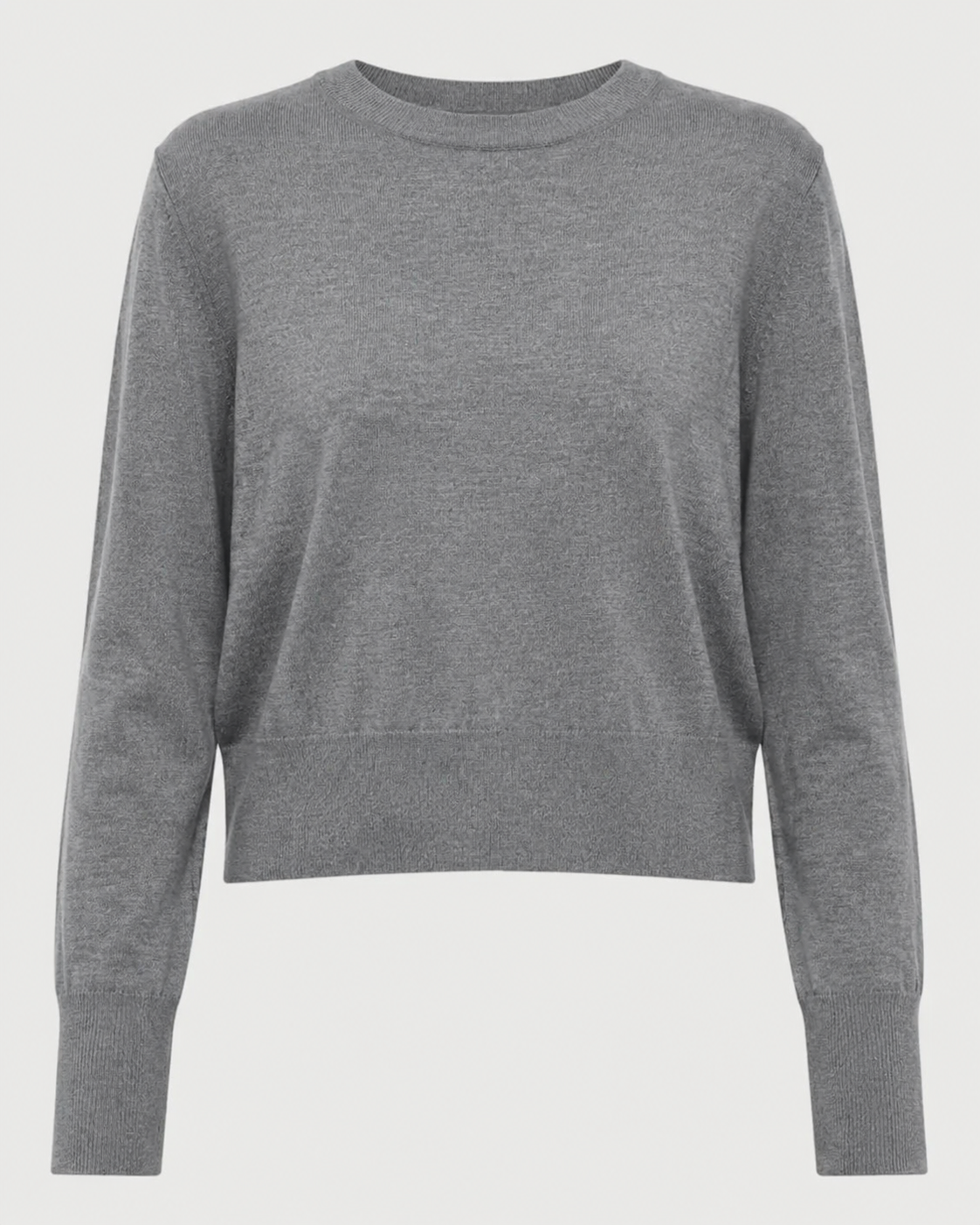 The Saint Art Elodie Sweater by Saint Art NY is a lightweight women’s crew neck sweater in grey, featuring long sleeves with ribbed cuffs and waistband, crafted from soft merino wool and shown against a white background.