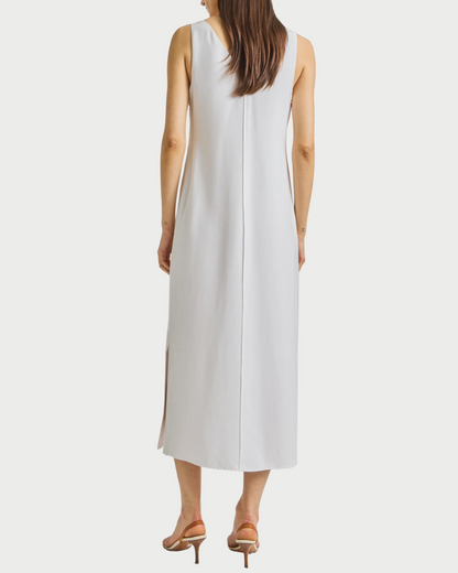 Woman wearing a white sleeveless dress on a white background