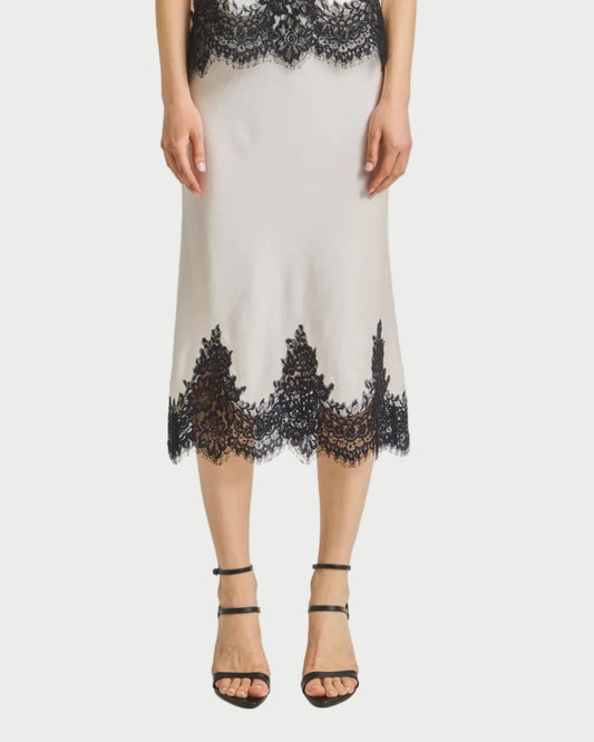 Woman wearing a skirt with black lace details on a white background