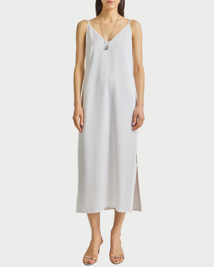 Woman wearing a white  slip dress on a white background