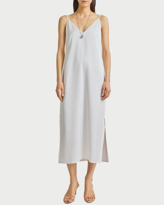 Woman wearing a white  slip dress on a white background