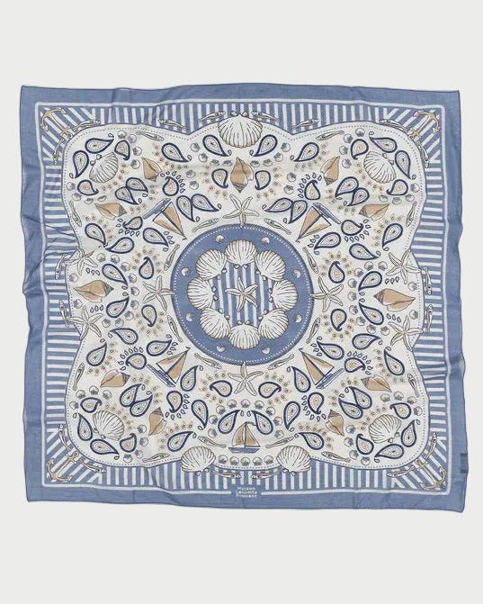 The Maison Lecomte Flament Bretagne Scarf by Maison Lecomte Flament is a square blue and white scarf with a maritime-inspired print featuring seashells, coral, paisley shapes, striped borders, and a central circular shell motif.