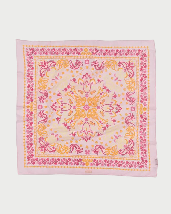 The Maison Lecomte Flament Noirmoutier Bandana Scarf is a chic square accessory with ornate floral and paisley prints in pink, yellow, and orange on a light background, finished with pink edges—a French-inspired piece from Maison Lecomte Flament.