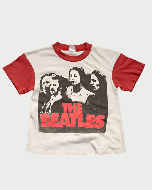 The Madeworn Beatles Tee is a vintage crop featuring red sleeves, a black and white image of the band members, and "THE BEATLES" in bold red on soft 100% cotton.
