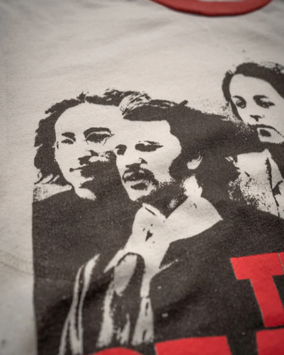 Close-up of the Madeworn Beatles Tee, showcasing a black-and-white print of four men with medium-length hair. The vintage fit and slightly faded image add charm, while the 100% cotton fabric and red collar enhance its classic appeal.