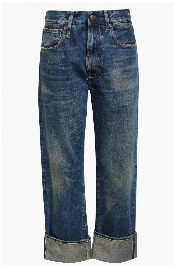 The R13 Cuffed X-BF Jean is a pair of blue boyfriend jeans with a faded wash, five pockets, and wide, rolled-up cuffs at the ankles.