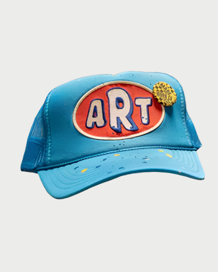 Blue cap with 'ART' logo on a textured surface