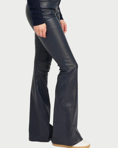 Person wearing midnight leather flared pants on a white background