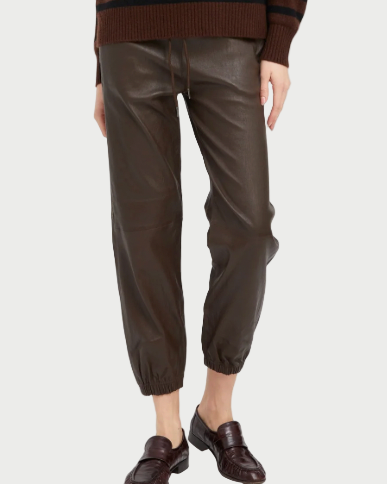 A person wearing SPRWMN Leather Drawstring Jogger pants with elastic ankle cuffs, a brown sweater, and dark brown loafers against a plain white background.