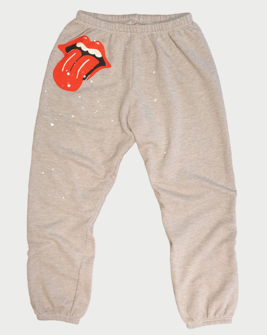 Gray sweatpants with Rolling Stones logo on a wooden surface