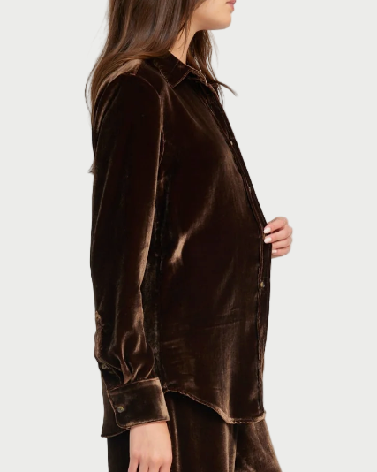 Woman wearing a brown velvet outfit on a white background