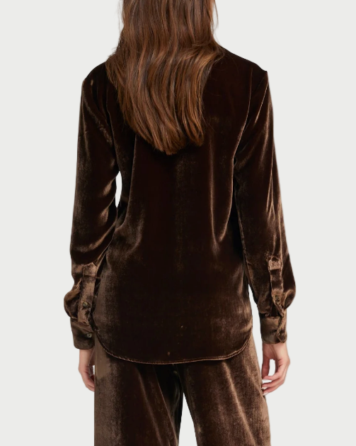 Person wearing a brown velvet outfit on a white background