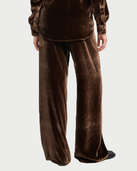 Person wearing a brown velvet suit on a white background