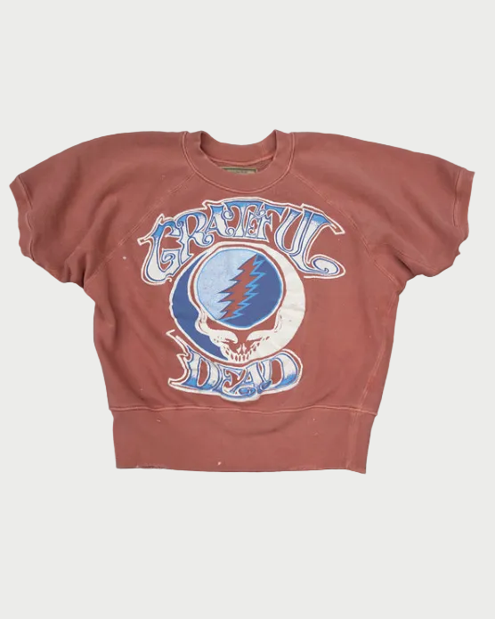 Brown short sleeve sweatshirt with Grateful Dead logo on a wooden surface
