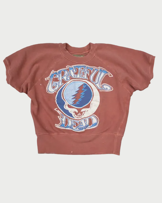 Brown short sleeve sweatshirt with Grateful Dead logo on a wooden surface
