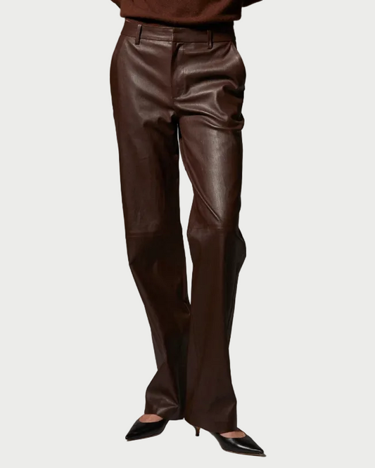 SPRWMN Low Rise Trouser in relaxed-fit, low-rise brown stretch leather worn with black pointed-toe heels.