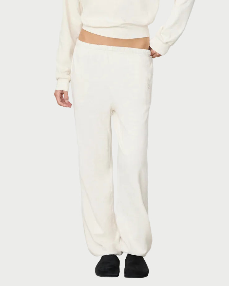 Woman wearing a white sweatpants with a plain background