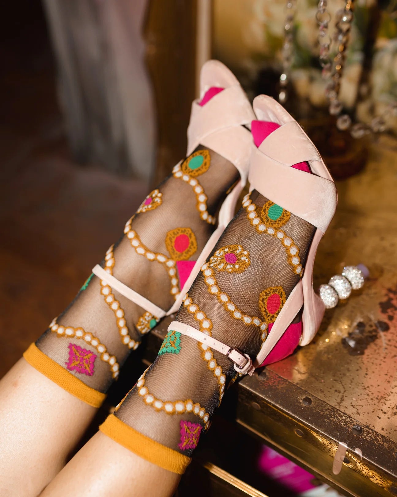 Decorative sheer socks with colorful patterns on a wooden surface.