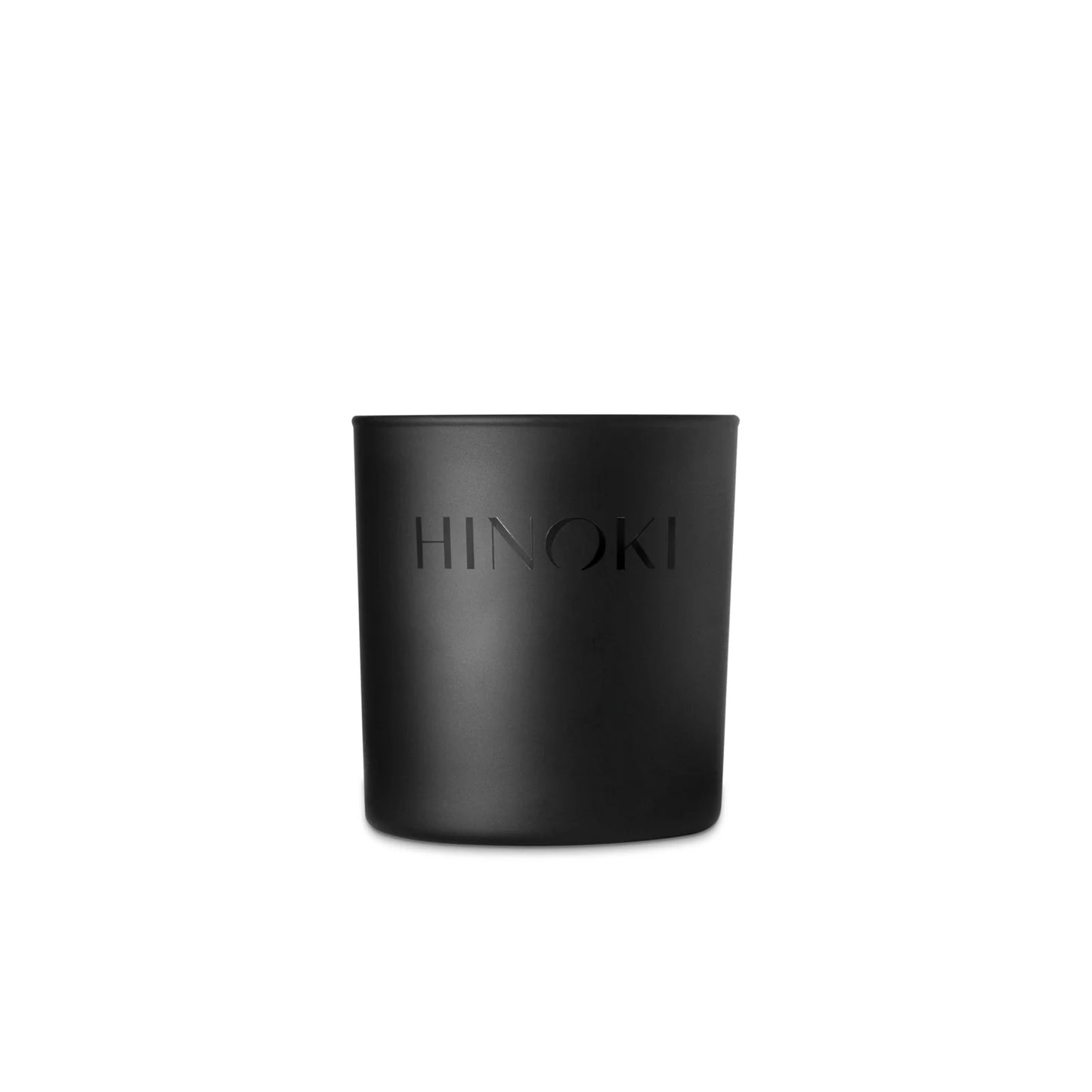 The Studio Stockhome Hinoki Candle features a matte black jar with "HINOKI" embossed on the front, reflecting Japanese cypress elegance and bringing a luxurious touch to any setting.
