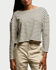 A woman wearing the perfectwhitetee Taylor Stripe Long Sleeve shirt paired with high-waisted beige pants.
