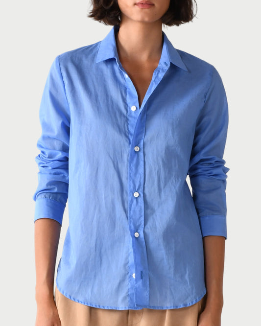 Woman wearing a blue shirt against a white background