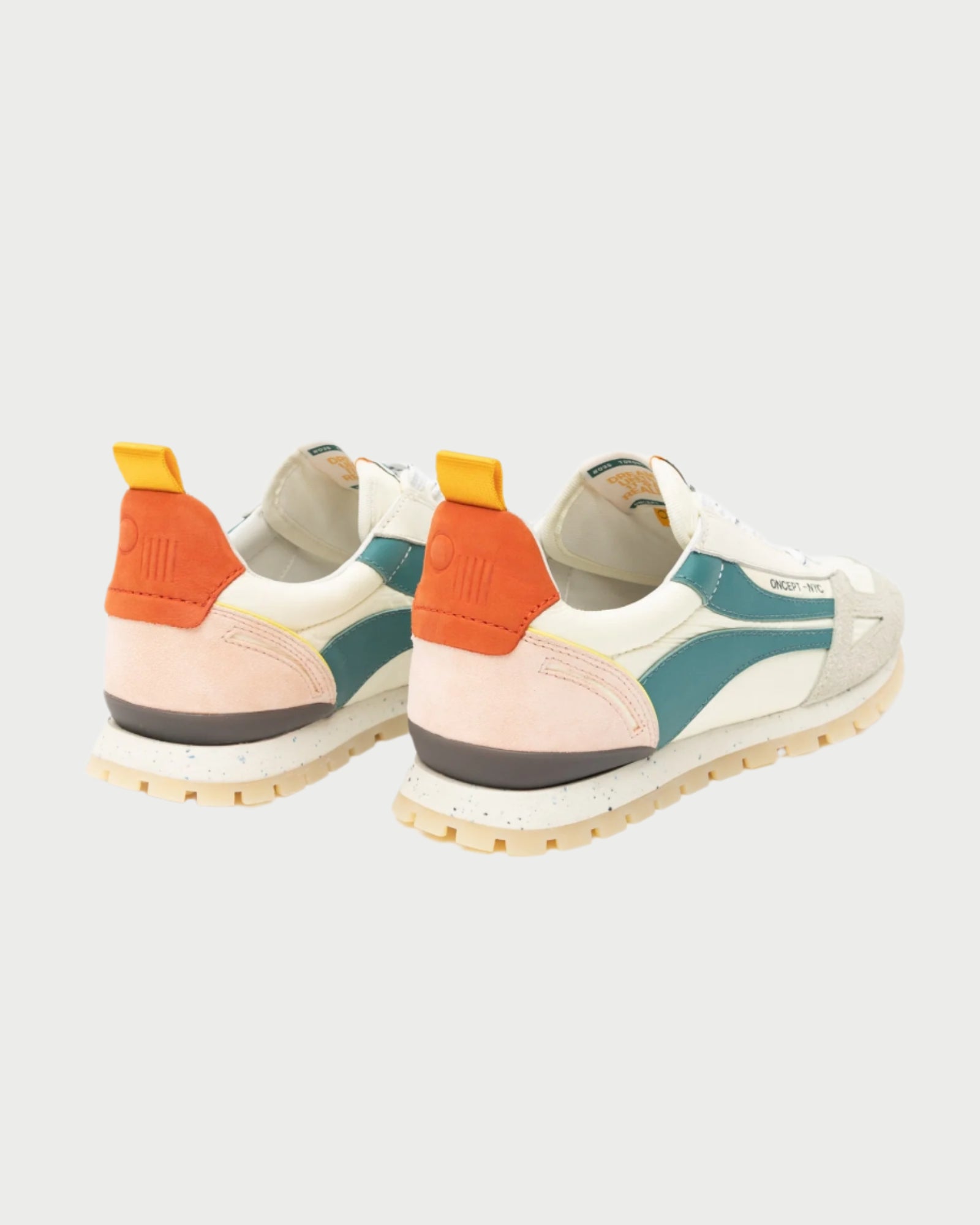 The Toronto Sneaker by Oncept, with teal, white, and peach accents, stands stylishly against a pale background. It features orange heel tabs, textured soles, and a logo on the side.