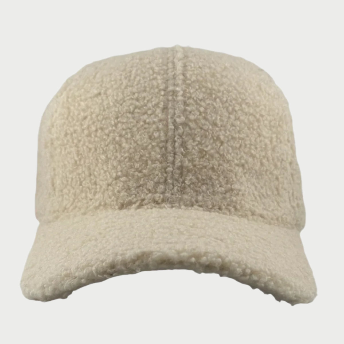 A front view of the Soulbyrd Teddy Trucker Hat features a cozy beige, textured wool design with a curved brim against a plain white background.