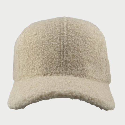 A front view of the Soulbyrd Teddy Trucker Hat features a cozy beige, textured wool design with a curved brim against a plain white background.