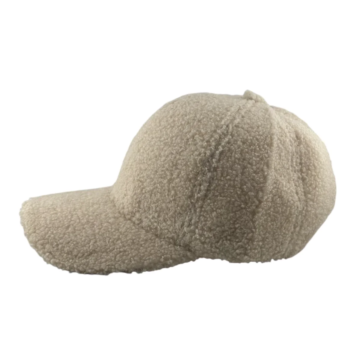 Experience the cozy charm of the Soulbyrd Teddy Trucker Hat. This beige sherpa cap features a soft, textured surface with a classic curved brim and six-panel construction, elegantly viewed from the side.