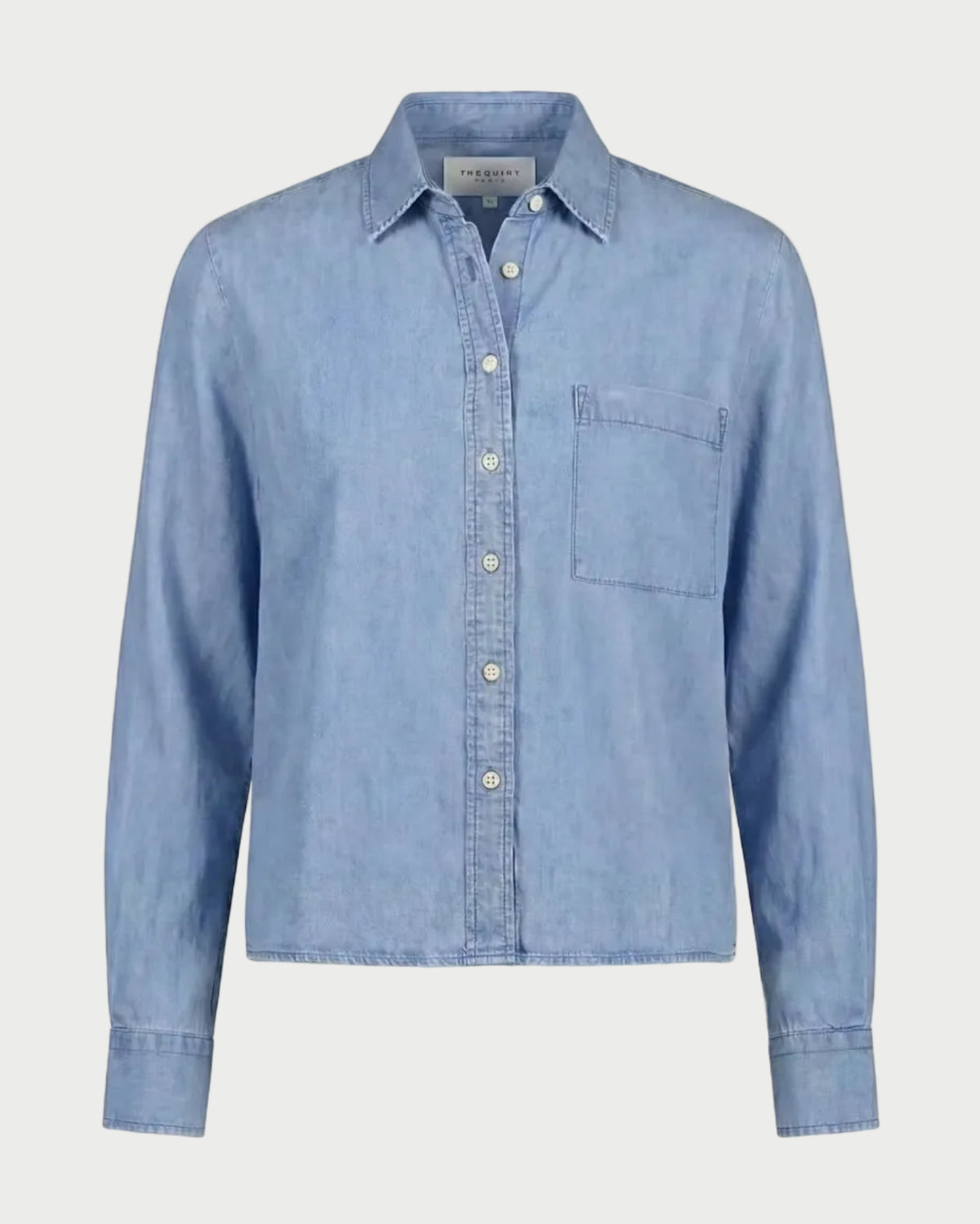 The Shirt Long Sleeve Boxy Crop in light blue, featuring a collar, front chest pocket, and a boxy cropped hem.
