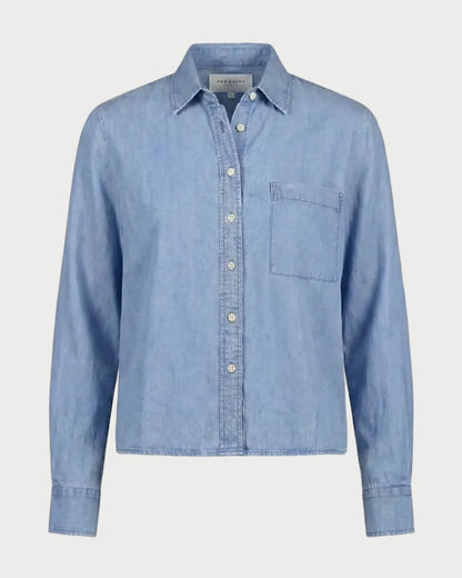 The Shirt Long Sleeve Boxy Crop in light blue, featuring a collar, front chest pocket, and a boxy cropped hem.