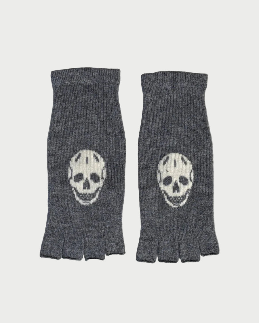 Pair of gray fingerless gloves with skull designs on a marble surface