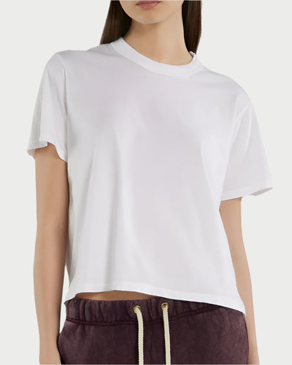 Someone wears a relaxed fit Jane Classic Tee from Les Tien in plain white and maroon drawstring pants, shown from shoulders to hips against a light background.