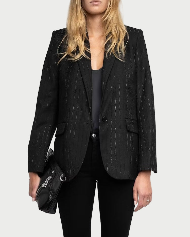 Person wearing a black suit and sunglasses on a white background