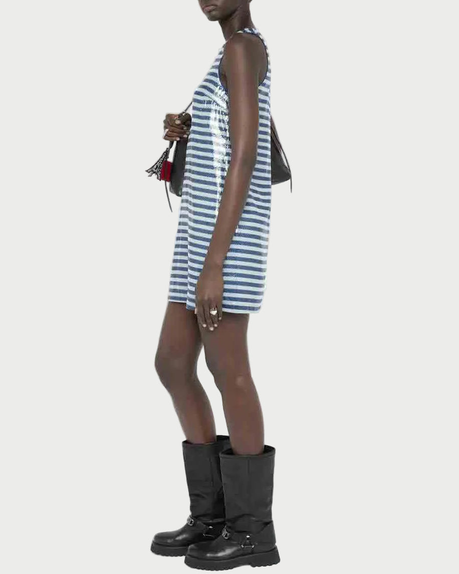 Woman wearing a blue and white striped dress with black boots on a white background