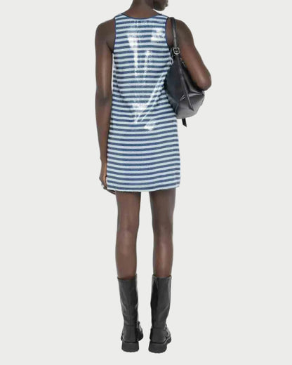 Person wearing a blue and white striped dress with a black backpack on a white background