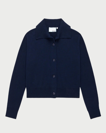 The Social Cardigan Navy by WE-AR4 is a dark blue button-up cardigan made from Merino Wool, featuring a collar and long sleeves, displayed on a plain white background.