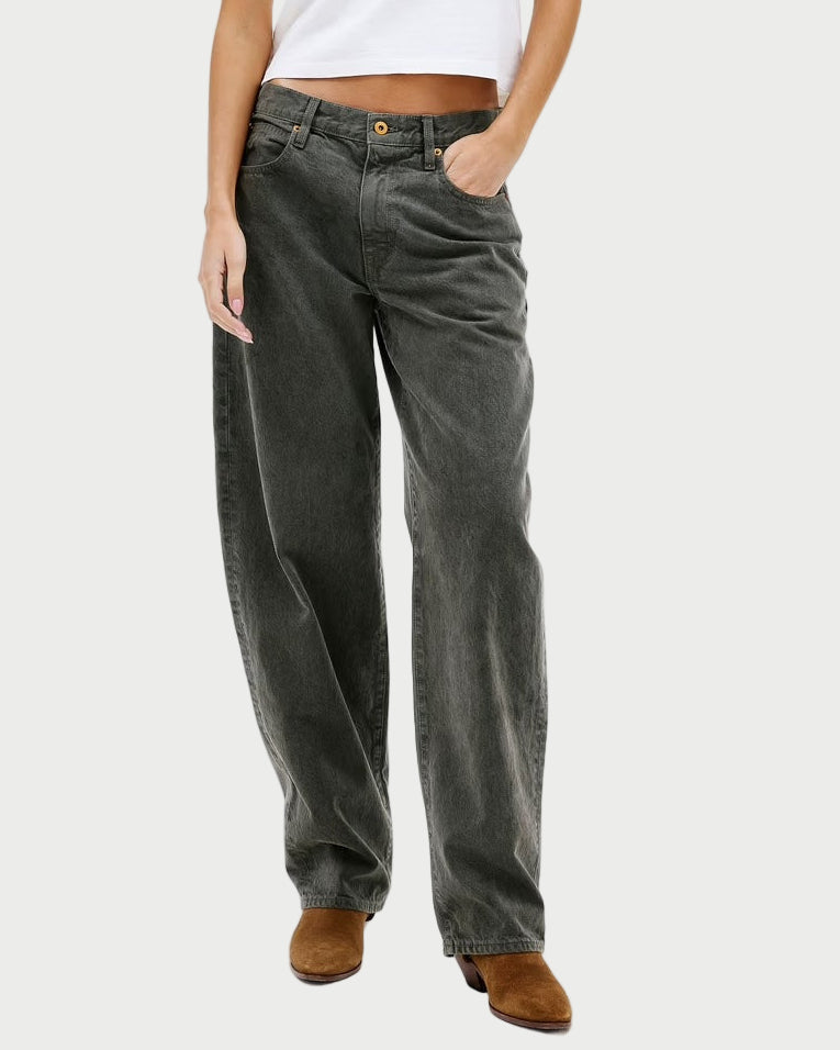 Woman wearing a white t-shirt and dark jeans on a white background