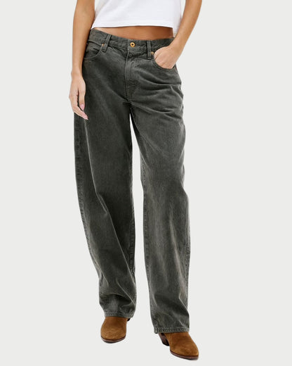 Woman wearing a white t-shirt and dark jeans on a white background