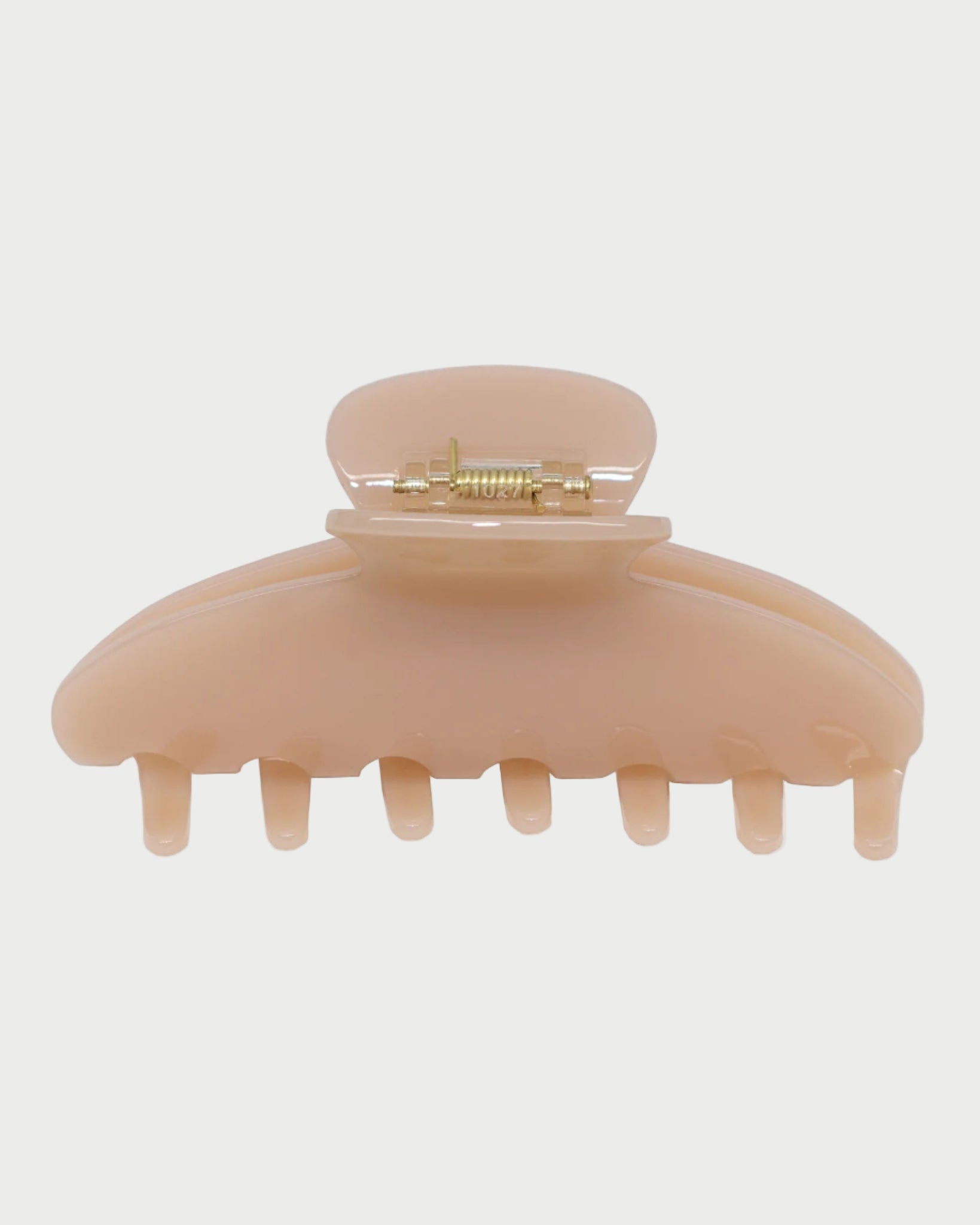 Beige hair clip on a white background