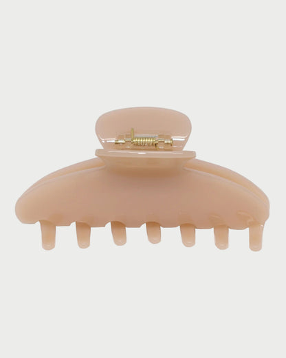 Beige hair clip on a white background